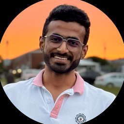 Portrait of Rishav Gupta, smiling, outdoors at sunset